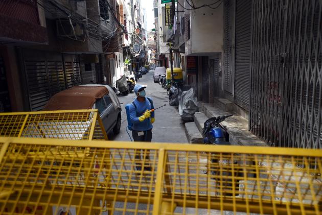 An MCD worker sprays disinfectant while sanitizing the West Vinod Nagar area. The declared containment zones comprise individual buildings — the Markaz in Nizamuddin, and three apartment complexes in east Delhi and one in Dwarka, neighbourhoods of Bengali Market, two blocks in Nizamuddin and one in Malviya Nagar, and congested alleys in Sadar and Laxmi Nagar. (Ajay Aggarwal / HT Photo) An MCD worker sprays disinfectant while sanitizing the West Vinod Nagar area. The declared containment zones comprise individual buildings — the Markaz in Nizamuddin, and three apartment complexes in east Delhi and one in Dwarka, neighbourhoods of Bengali Market, two blocks in Nizamuddin and one in Malviya Nagar, and congested alleys in Sadar and Laxmi Nagar. (Ajay Aggarwal / HT Photo)
