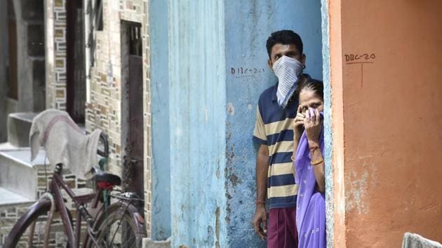 Residents with their faces covered, look on in a lane at Khichripur, another containment zone. Until Thursday, Delhi had 720 coronavirus positive cases, which included 12 deaths and 25 recoveries. (Ajay Aggarwal / HT Photo) Residents with their faces covered, look on in a lane at Khichripur, another containment zone. Until Thursday, Delhi had 720 coronavirus positive cases, which included 12 deaths and 25 recoveries. (Ajay Aggarwal / HT Photo)