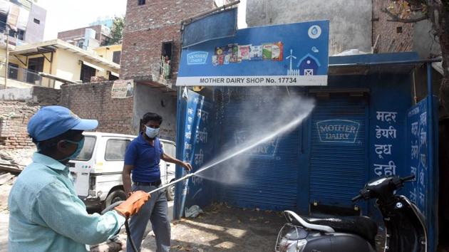 A municipal worker sprays disinfectant at Seemapuri, one of the Delhi’s hotspots, on day sixteen of the 21-day nationwide lockdown to limit the spread of coronavirus.(Sonu Mehta/HT PHOTO)