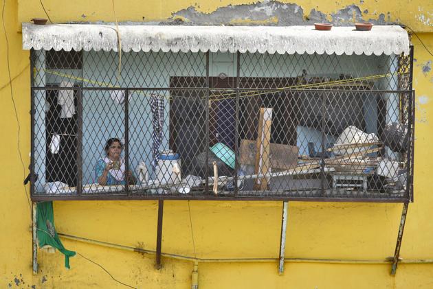 A woman looks out from her balcony in the sealed Nizamuddin Basti hotspot. From midnight on Wednesday, the police and city district administration started sealing some of the newly listed zones, even as it was business as usual in a few others till Thursday morning, despite the orders issued a day earlier. (Burhaan Kinu / HT PHOTO) A woman looks out from her balcony in the sealed Nizamuddin Basti hotspot. From midnight on Wednesday, the police and city district administration started sealing some of the newly listed zones, even as it was business as usual in a few others till Thursday morning, despite the orders issued a day earlier. (Burhaan Kinu / HT PHOTO)