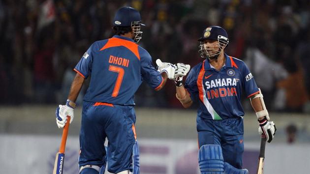 MS Dhoni and Sachin Tendulkar of India punch gloves during the fifth One Day International match between India and Australia at Rajiv Gandhi International Cricket Stadium on November 5, 2009 in Hyderabad, India.(Getty Images)