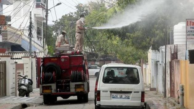 Municipal workers spray disinfectant on day 7 of national lockdown imposed to curb the spread of coronavirus in Jaipur, Rajasthan, India, on Tuesday, March 31, 2020.(Himanshu Vyas / Hindustan Times)