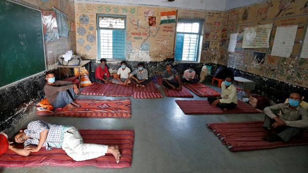 Migrant workers rest inside a classroom of a school turned into a shelter during a 21-day nationwide lockdown to slow the spreading of the coronavirus disease (COVID-19), in Ahmedabad.(REUTERS) Migrant workers rest inside a classroom of a school turned into a shelter during a 21-day nationwide lockdown to slow the spreading of the coronavirus disease (COVID-19), in Ahmedabad.(REUTERS)