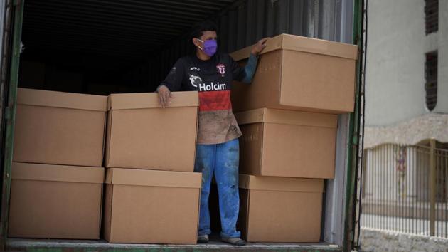 A man stands on a truck next to empty cardboard boxes being used as coffins due to an acute shortage outside a cemetery in Guayaquil, Ecuador. The frequency of deaths has authorities struggling to keep up. Those perishing to the disease are being kept in chilled shipping containers that serve as makeshift morgues. (Vicente Gaibor del Pino / REUTERS) A man stands on a truck next to empty cardboard boxes being used as coffins due to an acute shortage outside a cemetery in Guayaquil, Ecuador. The frequency of deaths has authorities struggling to keep up. Those perishing to the disease are being kept in chilled shipping containers that serve as makeshift morgues. (Vicente Gaibor del Pino / REUTERS)