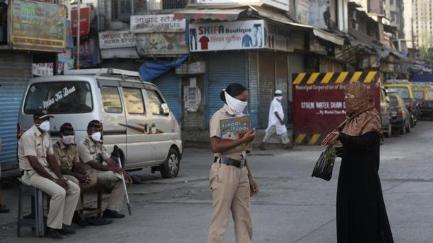 A police officer stops a woman in Dharavi, one of Asia's largest slums, during lockdown to prevent the spread of the new coronavirus in Mumbai. (AP) A police officer stops a woman in Dharavi, one of Asia's largest slums, during lockdown to prevent the spread of the new coronavirus in Mumbai. (AP)
