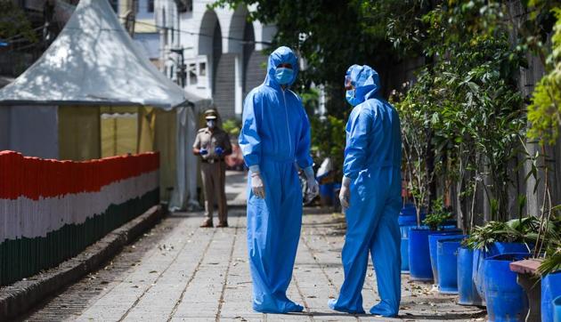 Members of a Delhi Police Crime Branch team in Personal Protection Equipment (PPE) kits during an investigation into the Tablighi Jamaat incident at the Alami Markaz Banglewali Masjid.(Amal KS/HT PHOTO)