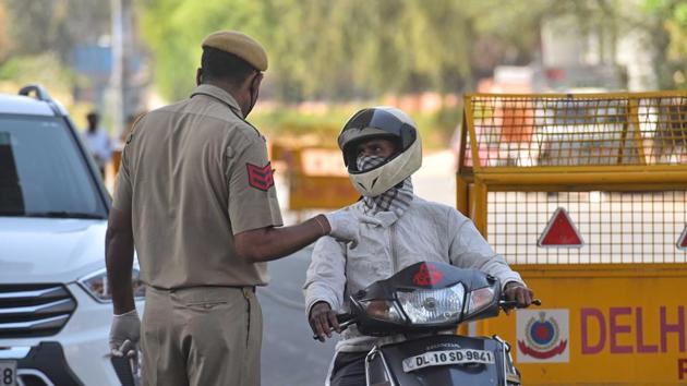 A Delhi Police personnel screen commuters for identity cards on day seventeen of the 21-day nationwide lockdown to curb the spread of coronavirus, in New Delhi. (Sanchit Khanna/HT PHOTO) A Delhi Police personnel screen commuters for identity cards on day seventeen of the 21-day nationwide lockdown to curb the spread of coronavirus, in New Delhi. (Sanchit Khanna/HT PHOTO)