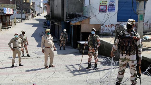 Security personnel stand guard near the barbed wire at a red zone declared area during the nationwide lockdown amid coronavirus pandemic, in Jammu, April 10, 2020. (ANI) Security personnel stand guard near the barbed wire at a red zone declared area during the nationwide lockdown amid coronavirus pandemic, in Jammu, April 10, 2020. (ANI)