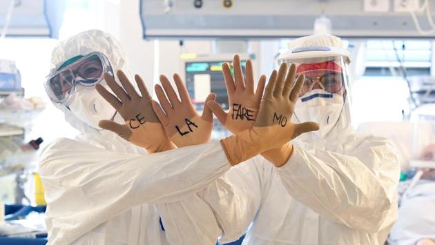 Medical staff members wearing protective gear show their hands with the words written on gloves “Ce la faremo” (We'll make it) written on them as they treat patients in the intensive care unit at the Circolo hospital in Varese, Italy. (Flavio L0 Scalzo / REUTERS) Medical staff members wearing protective gear show their hands with the words written on gloves “Ce la faremo” (We'll make it) written on them as they treat patients in the intensive care unit at the Circolo hospital in Varese, Italy. (Flavio L0 Scalzo / REUTERS)