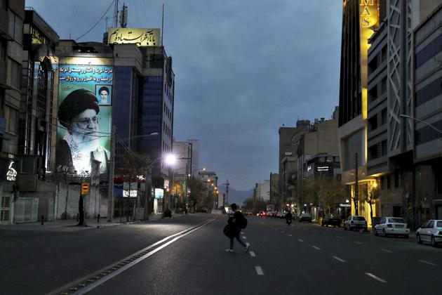 A pedestrian crosses an empty street with a portrait of Iran's Supreme Leader Ayatollah Ali Khamenei, in Tehran, Iran.(AP photo) A pedestrian crosses an empty street with a portrait of Iran's Supreme Leader Ayatollah Ali Khamenei, in Tehran, Iran.(AP photo)