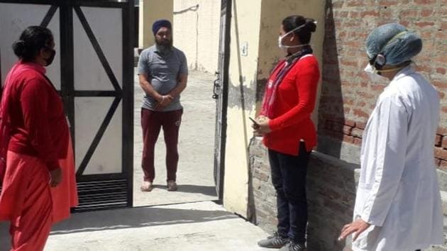A health team conducting door-to-door survey at Virk village in Jalandhar on Sunday.(HT PHOTO)