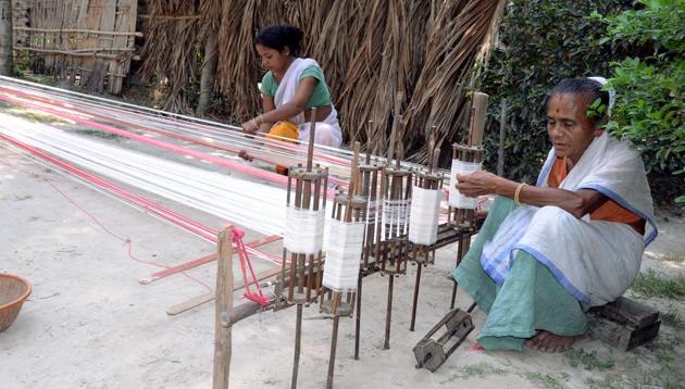 Two Assamese woman weave a ‘gamocha’ (towel) ahead of Rongali Bihu in a village on the outskirts of Tezpur . (ANI) Two Assamese woman weave a ‘gamocha’ (towel) ahead of Rongali Bihu in a village on the outskirts of Tezpur . (ANI)