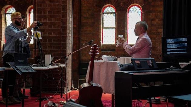 Pastor Matt Johnson leads an Easter service that is live-streamed via the internet for parishioners due to social gathering restrictions, at One1Seven evangelical Anglican church in Sydney, Australia on Sunday. Technology has come to aid believers in the face of a new illness that has changed the shape of society and altered the way religion is observed. (Loren Elliott / REUTERS)