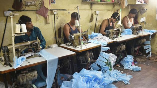 Workers sew masks in the wake of coronavirus in Mumbai. (PTI File Photo) Workers sew masks in the wake of coronavirus in Mumbai. (PTI File Photo)