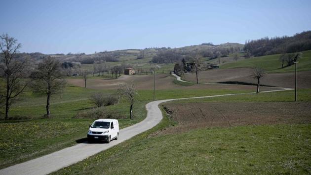 Michele Ferrari, the owner of a local supermarket drives his van in the countryside to deliver goods to local citizens. Ferrari makes sure that those who can’t venture forth much are at the top of his list for deliveries of basic necessities, whether fresh produce, meat or even the newspaper. (Piero Cruciatti / AFP) Michele Ferrari, the owner of a local supermarket drives his van in the countryside to deliver goods to local citizens. Ferrari makes sure that those who can’t venture forth much are at the top of his list for deliveries of basic necessities, whether fresh produce, meat or even the newspaper. (Piero Cruciatti / AFP)