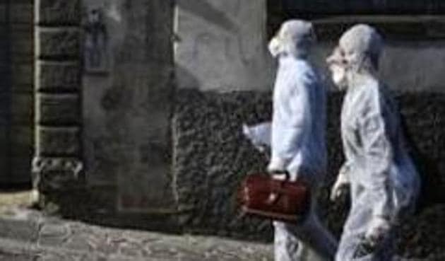 Medical staffers wearing protective gear, part of a special unit performing house calls, walk in Bergamo, northern Italy, one of the areas worse-affected by coronavirus, Wednesday, March 25, 2020. (AP) Medical staffers wearing protective gear, part of a special unit performing house calls, walk in Bergamo, northern Italy, one of the areas worse-affected by coronavirus, Wednesday, March 25, 2020. (AP)