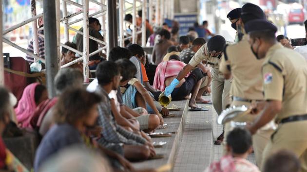 Railway Protection Force (RPF) personnel distribute food to homeless peoples on day eighteen of the 21 day nationwide lockdown to limit the coronavirus, at Howrah station in Kolkata, West Bengal,.(Photo by Samir Jana / Hindustan Times)