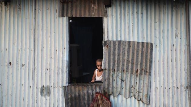 A child looks out from the window of a shanty during lockdown to control the coronavirus pandemic in Mumbai, India. (AP) A child looks out from the window of a shanty during lockdown to control the coronavirus pandemic in Mumbai, India. (AP)