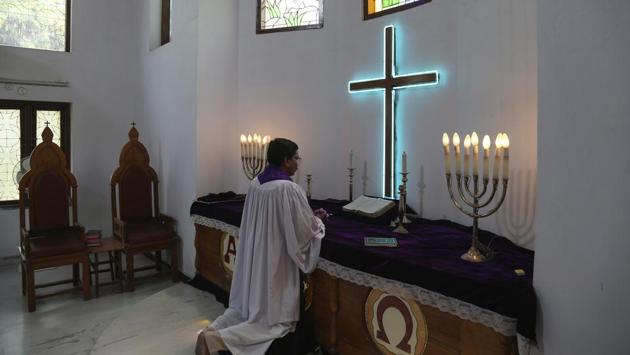 Protestant priest Sunil offers special prayers on Easter at Lutheran Church in Hyderabad on Sunday. The world observed a solitary Easter Sunday, blending the joyful feast day with sorrow over the toll the coronavirus has already taken. (MAhesh Kumar A. / AP)