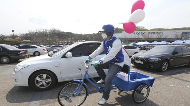 A man wearing a face mask rides a bicycle,Seoul, South Korea, Sunday, April 12, 2020. The coutry’s coronavirus cases have been slowing recently, compared with early March when it recorded hundreds of new cases every day.(AP)