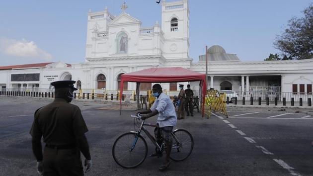A man rides past a police check point outside St.Anthony’s church, one of the sites attacked during last year’s Easter, in Colombo, Sri Lanka on Sunday, April 12. Sri Lanka’s Cardinal Malcolm Ranjith said in a televised Mass that the Roman Catholic Church had forgiven the suicide bombers who killed 279 people and wounded nearly 600 others last year. (Eranga Jayawardena / AP)