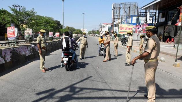 Police personnel check for the identity of commuters before allowing them to proceed at a checkpoint, on day nineteen of the 21-day lockdown to check the spread of coronavirus, in Lucknow, on April 12.(Dheeraj Dhawan/HT Photo) Police personnel check for the identity of commuters before allowing them to proceed at a checkpoint, on day nineteen of the 21-day lockdown to check the spread of coronavirus, in Lucknow, on April 12.(Dheeraj Dhawan/HT Photo)