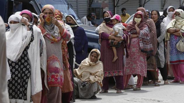 Women wait their turn to receive cash under the governmental Ehsaas Emergency Cash Programme for families in need, during a government-imposed nationwide lockdown to help contain the spread of the coronavirus, in Lahore.(AP) Women wait their turn to receive cash under the governmental Ehsaas Emergency Cash Programme for families in need, during a government-imposed nationwide lockdown to help contain the spread of the coronavirus, in Lahore.(AP)