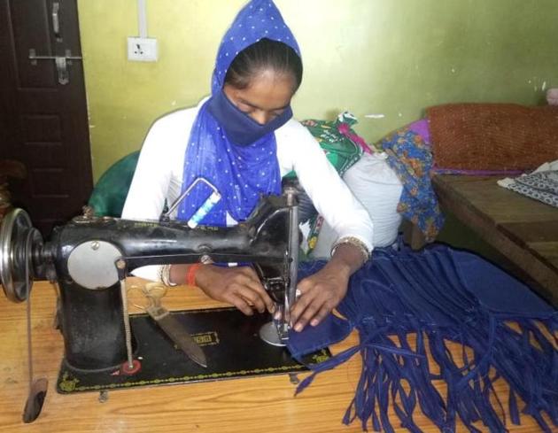 These women work in small groups in their respective areas and each group make some two hundred masks a day. (HT Photo) These women work in small groups in their respective areas and each group make some two hundred masks a day. (HT Photo)