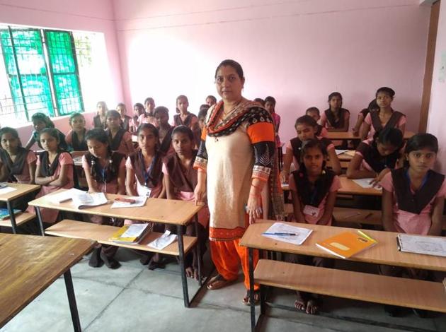 Students at a government-run upper primary school with their teacher.