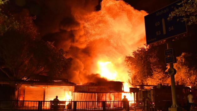 Fire fighters trying to douse the fire which broke out in the furniture market Sector 53, Chandigarh, on Monday night.(Keshav Singh/HT)