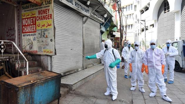 Health department workers disinfect the area near Nizamuddin Markaz, now a containment zone, on April 11. Covid-19 cases first jumped in India after the detection of hundreds of patients who attended gatherings of the Tablighi Jamaat in New Delhi’s Nizamuddin last month. Daily cases have surged since the cluster was identified and isolated on March 30. (Ajay Aggarwal / HT Photo)