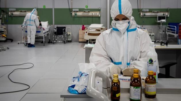 A medical worker prepares medicines inside a Covid-19 ward. The luxurious mall is now equipped with 3,000 beds-- offering all kinds of services to corona patients. (Ali Mohammadi / Bloomberg) A medical worker prepares medicines inside a Covid-19 ward. The luxurious mall is now equipped with 3,000 beds-- offering all kinds of services to corona patients. (Ali Mohammadi / Bloomberg)