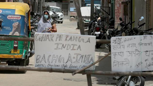 Messages urging people stay indoors at the blocked entrance to a lane where a Covid-19 positve case emerged in the walled city area of Jaipur.(Himanshu Vyas/HT PHOTO)