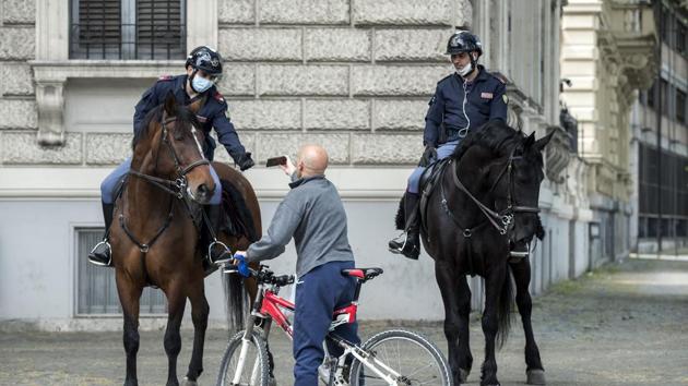 Police officers on horseback stop a cyclist for controls, in Rome, Monday, April 13, 2020. (AP) Police officers on horseback stop a cyclist for controls, in Rome, Monday, April 13, 2020. (AP)