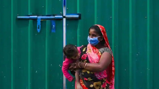 A woman holds her baby as she waits to collect food at Safdarjung Enclave during lockdown, in New Delhi, India, on Tuesday, April 14, 2020. (Amal KS/HT Photo) A woman holds her baby as she waits to collect food at Safdarjung Enclave during lockdown, in New Delhi, India, on Tuesday, April 14, 2020. (Amal KS/HT Photo)