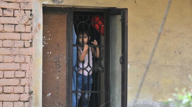 A child looks anxiously out of his window amid lockdown in Chandigarh on Wednesday. (Ravi Kumar/HT) A child looks anxiously out of his window amid lockdown in Chandigarh on Wednesday. (Ravi Kumar/HT)
