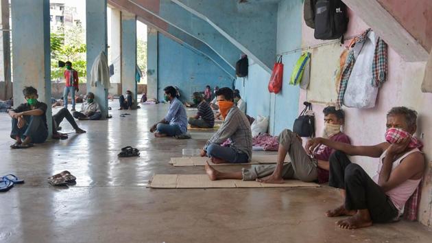 Migrant workers and homeless people rest at a temporary camp set up on the premises of a stadium, during the ongoing COVID-19 lockdown in Thane. (Mitesh Bhuvad / PTI)