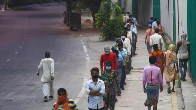 Stranded migrant workers and homeless people queue to collect food at Safdarjung Enclave during lockdown, in New Delhi, India, on Tuesday, April 14, 2020. (Amal KS/HT PHOTO) Stranded migrant workers and homeless people queue to collect food at Safdarjung Enclave during lockdown, in New Delhi, India, on Tuesday, April 14, 2020. (Amal KS/HT PHOTO)