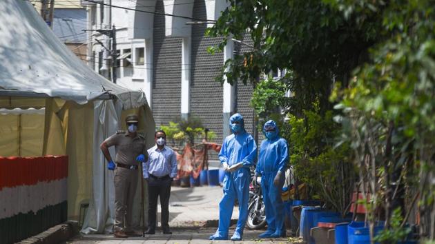 Members of a Delhi Police Crime Branch team in Personal Protection Equipment (PPE) kits during an investigation into the Tablighi Jamaat incident at the Alami Markaz Banglewali Masjid, on day twelve of the 21 day nationwide lockdown to check the spread of coronavirus, in Nizamuddin, New Delhi, India, on Sunday, April 5, 2020. (Amal KS/HT PHOTO) Members of a Delhi Police Crime Branch team in Personal Protection Equipment (PPE) kits during an investigation into the Tablighi Jamaat incident at the Alami Markaz Banglewali Masjid, on day twelve of the 21 day nationwide lockdown to check the spread of coronavirus, in Nizamuddin, New Delhi, India, on Sunday, April 5, 2020. (Amal KS/HT PHOTO)