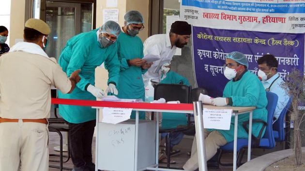 Doctors and medical workers in protective face masks and hairnets at a COVID-19 help desk at Civil Hospital Sector 10, in Gurugram, India, on April 13, 2020. (Yogendra Kumar/HT PHOTO) Doctors and medical workers in protective face masks and hairnets at a COVID-19 help desk at Civil Hospital Sector 10, in Gurugram, India, on April 13, 2020. (Yogendra Kumar/HT PHOTO)