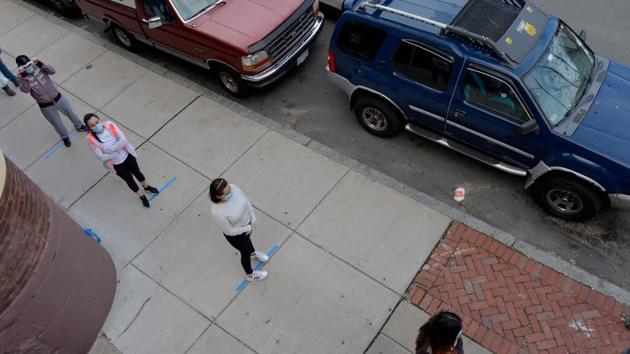 Social distancing is observed as hundreds of people line up to receive food and goods donated to the Chelsea Collaborative Inc. to be given out at the Pan Y Cafe in Chelsea, Massachusetts on April 14, 2020. (AFP photo) Social distancing is observed as hundreds of people line up to receive food and goods donated to the Chelsea Collaborative Inc. to be given out at the Pan Y Cafe in Chelsea, Massachusetts on April 14, 2020. (AFP photo)