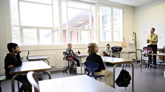 Denmark's Prime Minister Mette Frederiksen, right, speaks to pupils during the reopening of Lykkebo School in Copenhagen, Wednesday, April 15, 2020. Denmark is beginning to relax its strict coronavirus lockdown measures by allowing some classes to return nationwide Wednesday to school. (AP) Denmark's Prime Minister Mette Frederiksen, right, speaks to pupils during the reopening of Lykkebo School in Copenhagen, Wednesday, April 15, 2020. Denmark is beginning to relax its strict coronavirus lockdown measures by allowing some classes to return nationwide Wednesday to school. (AP)