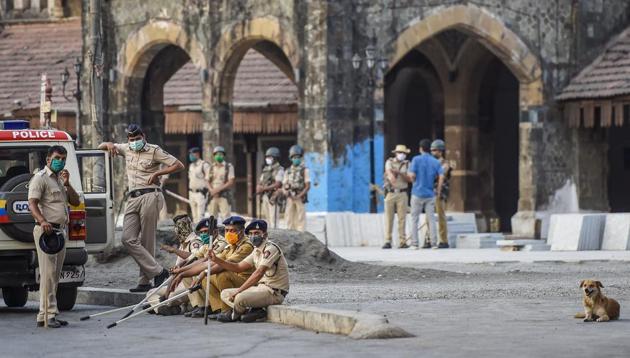 Police official take rest after dispersing hundreds of stranded migrant workers from outside the Bandra Railway Station in Mumbai, Tuesday, April 14, 2020. (PTI photo) Police official take rest after dispersing hundreds of stranded migrant workers from outside the Bandra Railway Station in Mumbai, Tuesday, April 14, 2020. (PTI photo)