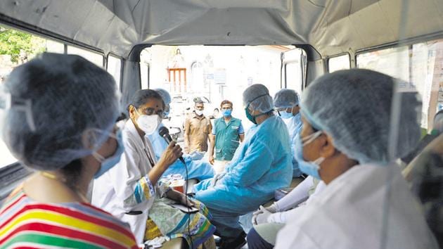 A team of medical personnel check patients for symptoms of Covid-19 in the Ghorpade peth area on Wednesday. (Rahul Raut) A team of medical personnel check patients for symptoms of Covid-19 in the Ghorpade peth area on Wednesday. (Rahul Raut)