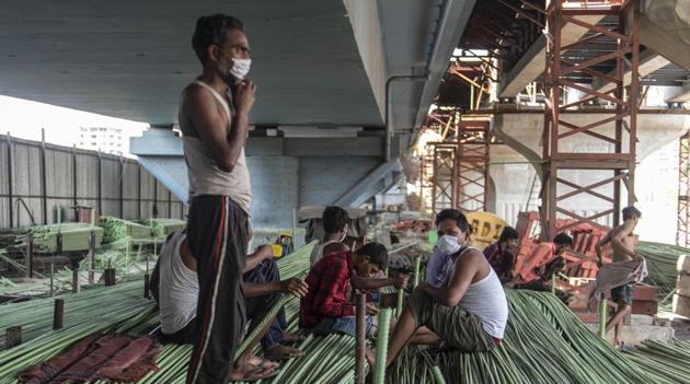 Migrant workers who were working on a flyover project sit idle as the construction is on halt during lockdown due to corona virus, Chembur, Mumbai, India, on Friday, April 03 2020.(Photo by Aalok Soni/Hindustan Times)