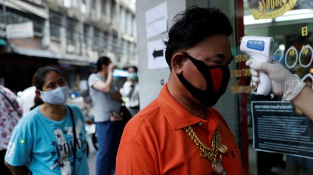A man has his temperature checked before he is allowed in a goldsmith store as demand for cash increases after the partial shut down caused by the outbreak of the coronavirus disease hurts the local economy in Bangkok.(Reuters Photo)