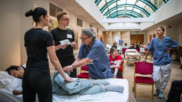 People laid off over COVID-19 in Sweden listen to instructors during a course retraining them to work in hospitals and care homes in Stockholm. The measure is part of Sweden’s softer approach to containing the coronavirus, an outlier in Europe. As of Wednesday, a total of 1,203 people had died from nearly 12,000 confirmed cases. (Jonathan Nackstrand / AFP) People laid off over COVID-19 in Sweden listen to instructors during a course retraining them to work in hospitals and care homes in Stockholm. The measure is part of Sweden’s softer approach to containing the coronavirus, an outlier in Europe. As of Wednesday, a total of 1,203 people had died from nearly 12,000 confirmed cases. (Jonathan Nackstrand / AFP)