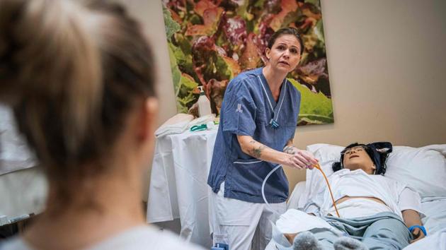 Instructor Christina Riddeback, a Stockholm region nurse, said the initiative was well-timed given the rising cases in Sweden’s nursing homes. “Slowly, COVID-19 is spreading among this group of people,” she said, standing next to a gurney with a dummy laid out for the students. (Jonathan Nackstrand / AFP) Instructor Christina Riddeback, a Stockholm region nurse, said the initiative was well-timed given the rising cases in Sweden’s nursing homes. “Slowly, COVID-19 is spreading among this group of people,” she said, standing next to a gurney with a dummy laid out for the students. (Jonathan Nackstrand / AFP)