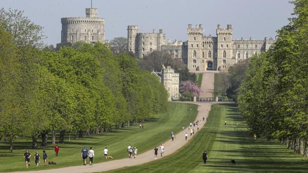 Covid-19 in UK: People exercise social distancing as they take their exorcise on the Long Walk in front of Windsor Castle during the Easter bank holiday weekend, as the UK continues in lockdown to help curb the spread of the coronavirus, in Windsor, England. (AP) Covid-19 in UK: People exercise social distancing as they take their exorcise on the Long Walk in front of Windsor Castle during the Easter bank holiday weekend, as the UK continues in lockdown to help curb the spread of the coronavirus, in Windsor, England. (AP)