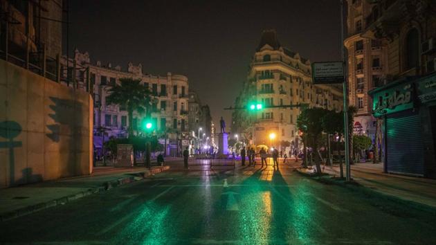 Egyptian security forces cordon off roads during curfew hours in Cairo. Known for its nightlife, the Egyptian capital is now being forced to go to bed in an effort to slow the spread of the coronavirus through its around 20 million residents. (Nariman El-Mofty / AP) Egyptian security forces cordon off roads during curfew hours in Cairo. Known for its nightlife, the Egyptian capital is now being forced to go to bed in an effort to slow the spread of the coronavirus through its around 20 million residents. (Nariman El-Mofty / AP)